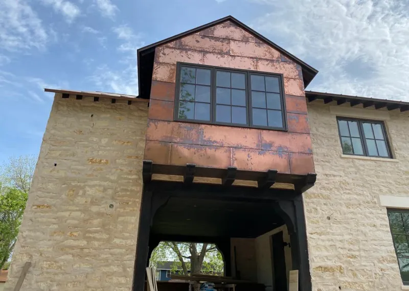 Copper metal panel facade on a stone building for Skylight Installation in Garden Grove